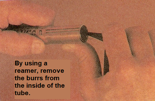 By using a reamer remove the burrs from the inside of the tube